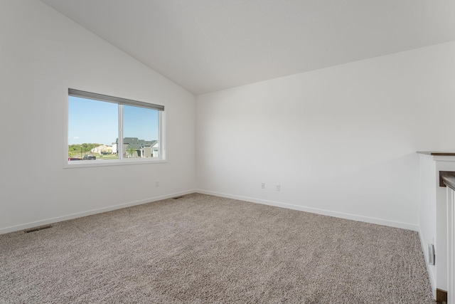 1129 Tiger Ct NE, Isanti, MN 55040 - carpeted empty room with lofted ceiling and baseboards