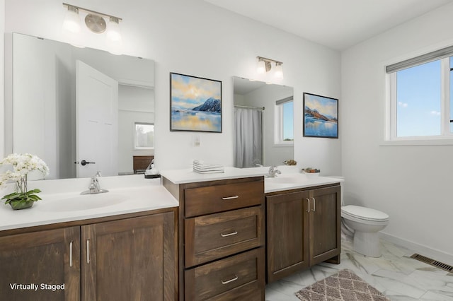 1129 Tiger Ct NE, Isanti, MN 55040 - full bathroom with vanity, plenty of natural light, marble look tiles, and toilet