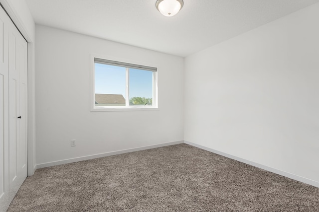 1129 Tiger Ct NE, Isanti, MN 55040 - unfurnished bedroom featuring carpet flooring, a closet, and baseboards