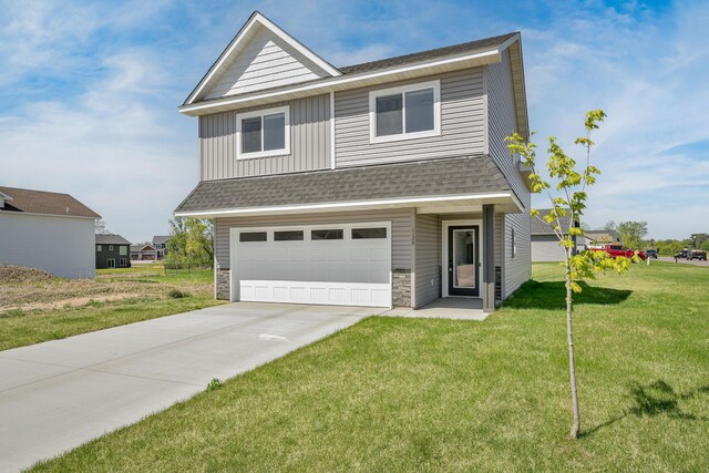 1129 Tiger Ct NE, Isanti, MN 55040 - view of front of property with an attached garage, a shingled roof, a front lawn, concrete driveway, and board and batten siding