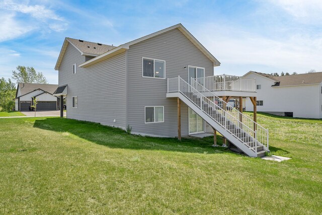 1129 Tiger Ct NE, Isanti, MN 55040 - back of property featuring stairs, a deck, and a lawn