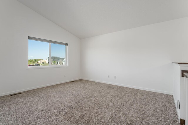 1129 Tiger Ct NE, Isanti, MN 55040 - empty room featuring vaulted ceiling, carpet flooring, and baseboards