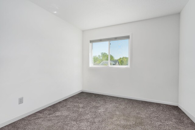 1129 Tiger Ct NE, Isanti, MN 55040 - spare room featuring carpet and baseboards