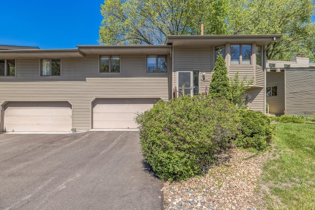 1567 Bavarian Pass, Fridley, MN 55432 - split foyer home featuring a garage and asphalt driveway