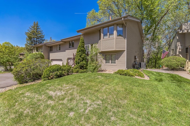 1567 Bavarian Pass, Fridley, MN 55432 - view of front of house with cooling unit and a front lawn