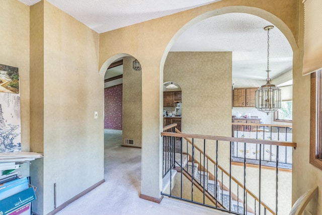 1567 Bavarian Pass, Fridley, MN 55432 - corridor with a chandelier, arched walkways, carpet, an upstairs landing, and baseboards