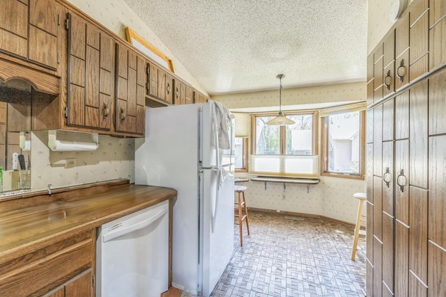 1567 Bavarian Pass, Fridley, MN 55432 - kitchen with white appliances, brown cabinets, a textured ceiling, wallpapered walls, and vaulted ceiling