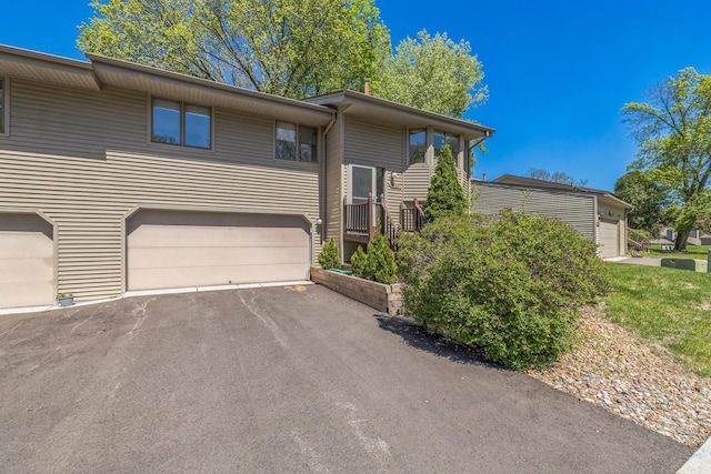 1567 Bavarian Pass, Fridley, MN 55432 - view of front of house featuring an attached garage and asphalt driveway