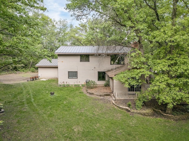 13640 Alamo St NE, Ham Lake, MN 55304 - back of property featuring a yard, metal roof, and a chimney