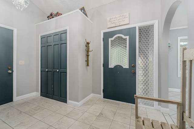 13640 Alamo St NE, Ham Lake, MN 55304 - foyer with arched walkways, light marble finish floors, baseboards, and lofted ceiling