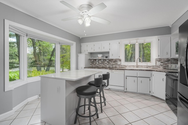 13640 Alamo St NE, Ham Lake, MN 55304 - kitchen featuring dishwasher, tasteful backsplash, light stone countertops, light tile patterned flooring, and crown molding