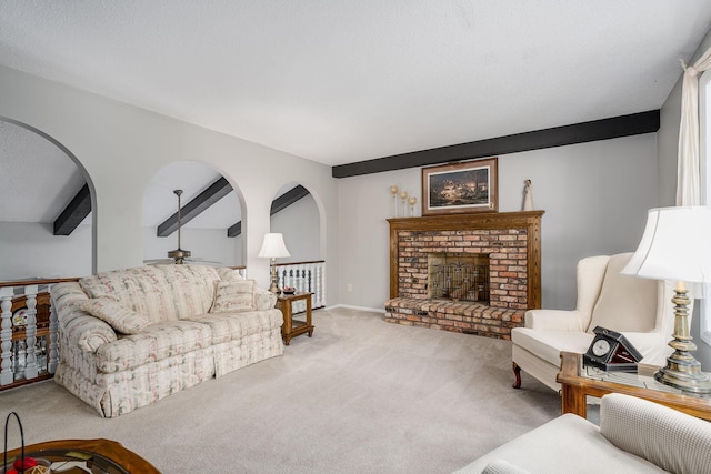 13640 Alamo St NE, Ham Lake, MN 55304 - carpeted living room with beamed ceiling, a brick fireplace, a ceiling fan, and arched walkways