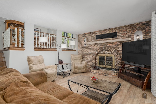 13640 Alamo St NE, Ham Lake, MN 55304 - living room featuring wood finished floors, a fireplace, and stairs