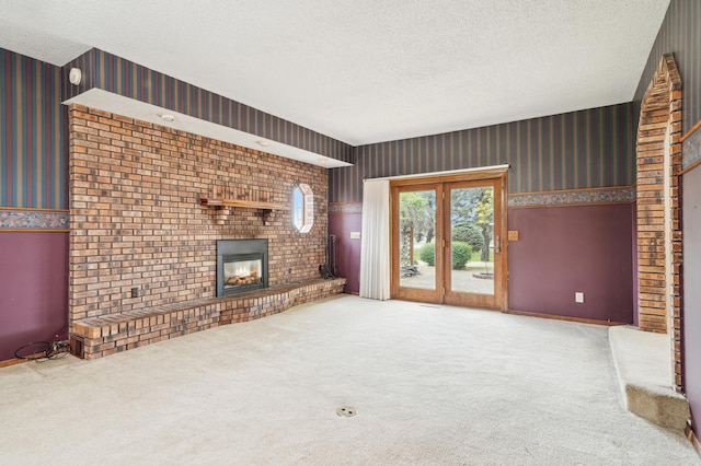 22800 401st Ave, Arlington Twp, MN 55307 - unfurnished living room featuring wallpapered walls, a textured ceiling, a fireplace, carpet flooring, and baseboards