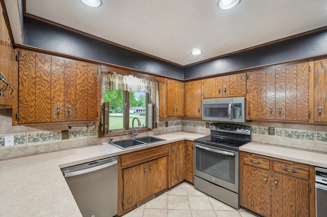 22800 401st Ave, Arlington Twp, MN 55307 - kitchen featuring stainless steel appliances, a sink, light countertops, brown cabinets, and backsplash