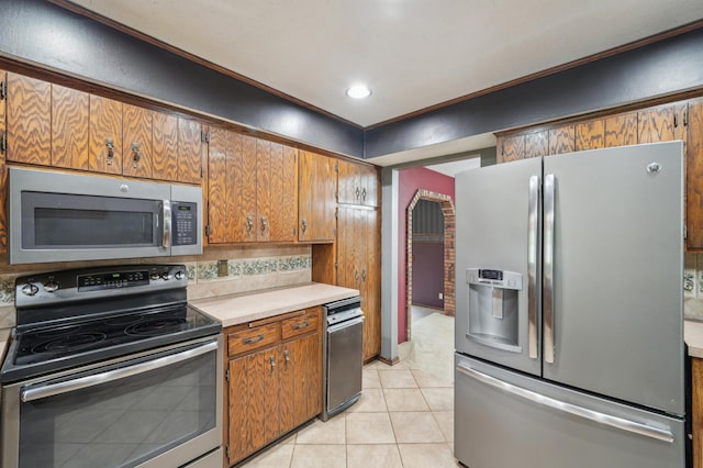 22800 401st Ave, Arlington Twp, MN 55307 - kitchen featuring stainless steel appliances, light countertops, decorative backsplash, light tile patterned flooring, and brown cabinets