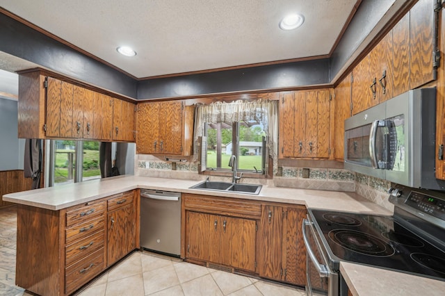 22800 401st Ave, Arlington Twp, MN 55307 - kitchen featuring stainless steel appliances, a sink, brown cabinetry, backsplash, and light countertops