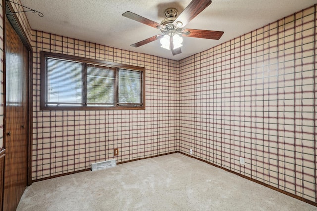 22800 401st Ave, Arlington Twp, MN 55307 - carpeted empty room featuring wallpapered walls, a textured ceiling, baseboards, and ceiling fan