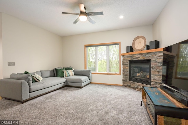 carpeted living room with a fireplace, a ceiling fan, baseboards, and recessed lighting