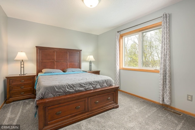 bedroom featuring carpet floors and baseboards