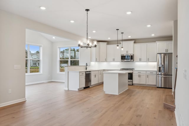 kitchen featuring appliances with stainless steel finishes, light wood-style flooring, white cabinetry, light countertops, and recessed lighting