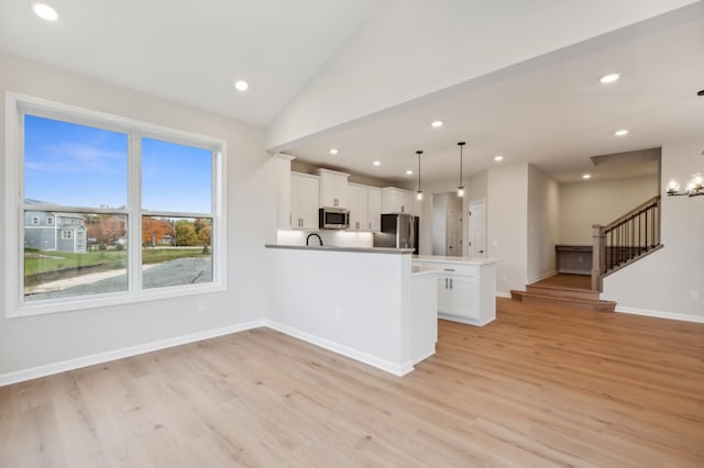 kitchen with stainless steel appliances, light wood-style floors, recessed lighting, white cabinetry, and baseboards