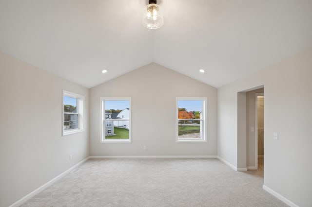 unfurnished room featuring vaulted ceiling, light colored carpet, baseboards, and recessed lighting
