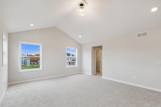 unfurnished room with light colored carpet, vaulted ceiling, baseboards, and recessed lighting