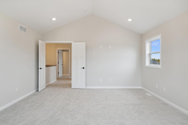 unfurnished bedroom with vaulted ceiling, light colored carpet, baseboards, and recessed lighting
