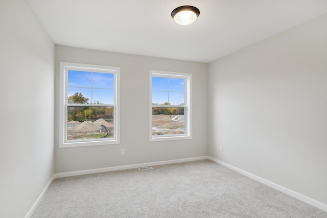 empty room with carpet and baseboards