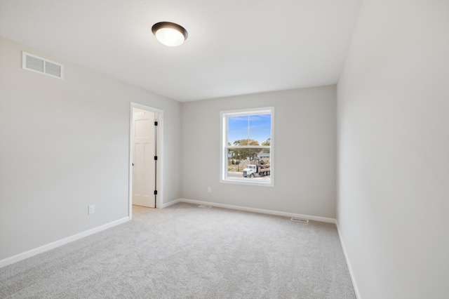 carpeted spare room with baseboards