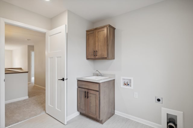 laundry room with electric dryer hookup, hookup for a washing machine, cabinet space, and baseboards