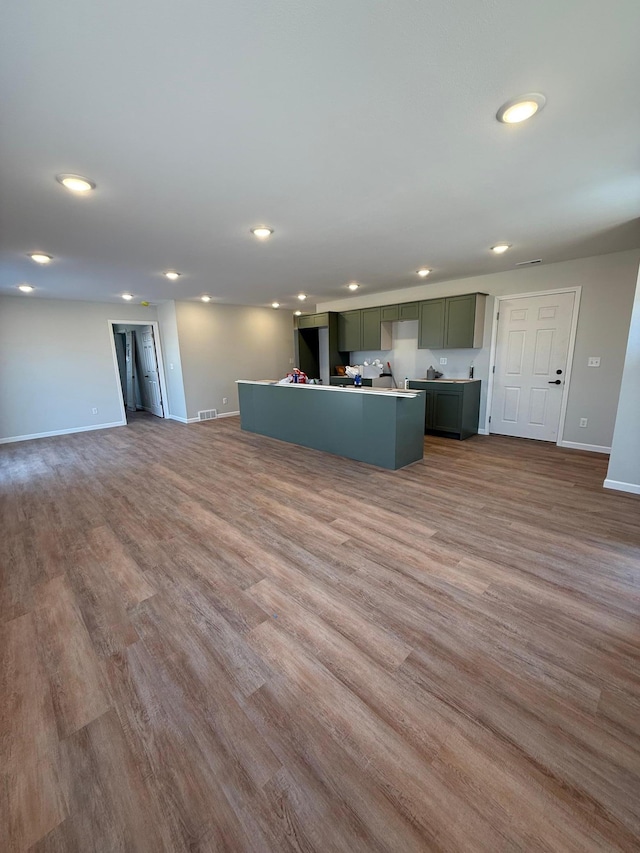 6809 Hamilton Park NW Unit 12, Bemidji, MN 56601 - unfurnished living room featuring recessed lighting, baseboards, and wood finished floors