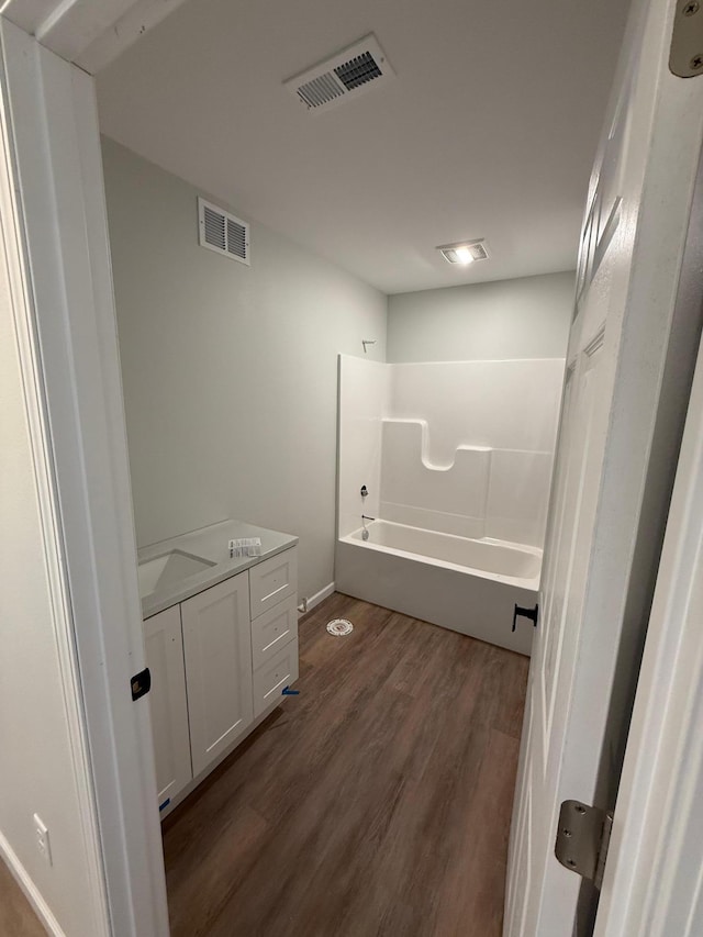 6809 Hamilton Park NW Unit 12, Bemidji, MN 56601 - bathroom with wood finished floors, shower / tub combination, and baseboards