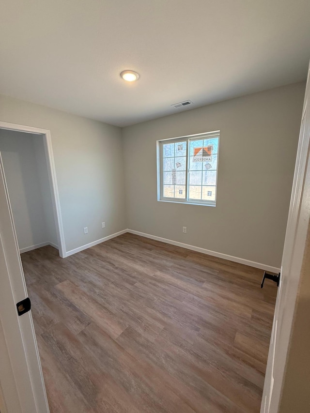 6809 Hamilton Park NW Unit 12, Bemidji, MN 56601 - unfurnished bedroom featuring wood finished floors and baseboards