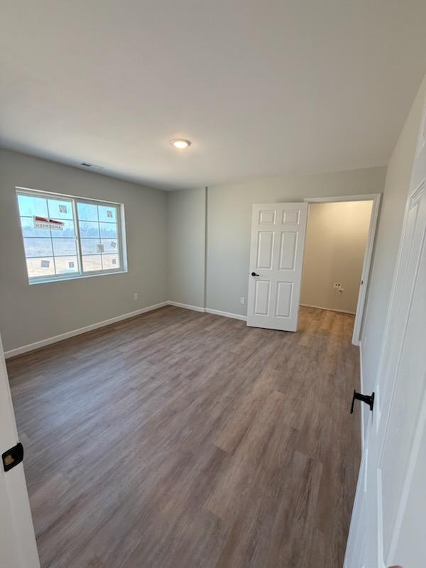 6809 Hamilton Park NW Unit 12, Bemidji, MN 56601 - unfurnished bedroom featuring wood finished floors and baseboards