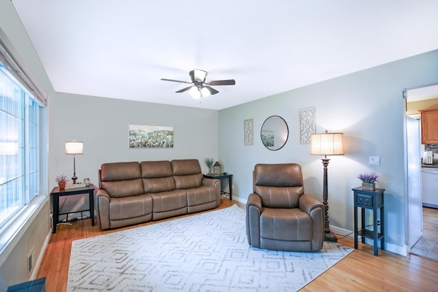 726 17th St NE, Owatonna, MN 55060 - living area with ceiling fan, light wood-type flooring, and baseboards