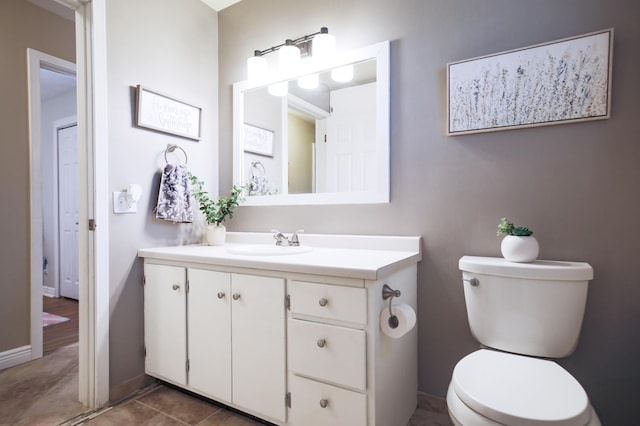 726 17th St NE, Owatonna, MN 55060 - bathroom with toilet, vanity, and baseboards