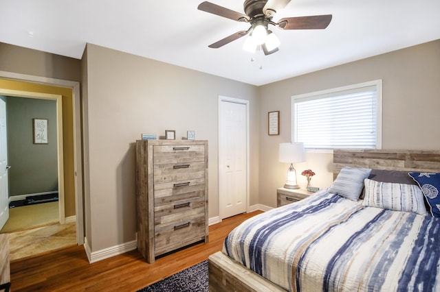 726 17th St NE, Owatonna, MN 55060 - bedroom featuring wood finished floors, baseboards, a ceiling fan, and a closet