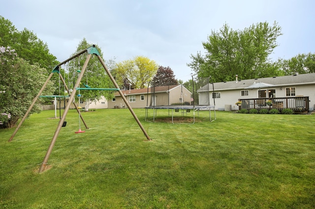 726 17th St NE, Owatonna, MN 55060 - view of green lawn with a trampoline, a playground, and a deck
