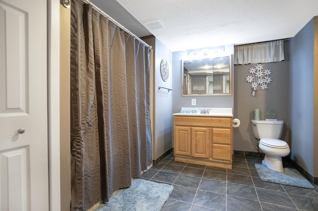 726 17th St NE, Owatonna, MN 55060 - bathroom featuring toilet, tile patterned flooring, baseboards, vanity, and a textured ceiling