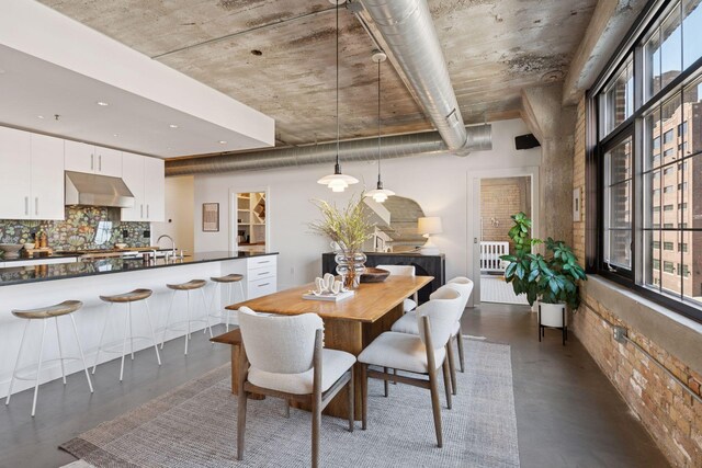 dining space featuring plenty of natural light and concrete floors