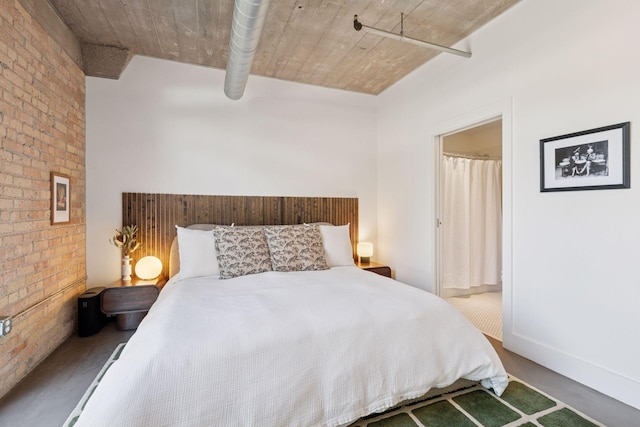 bedroom featuring brick wall