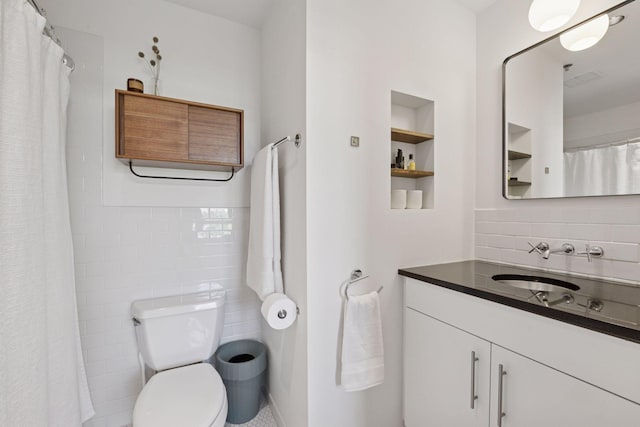 bathroom featuring decorative backsplash, vanity, toilet, and curtained shower
