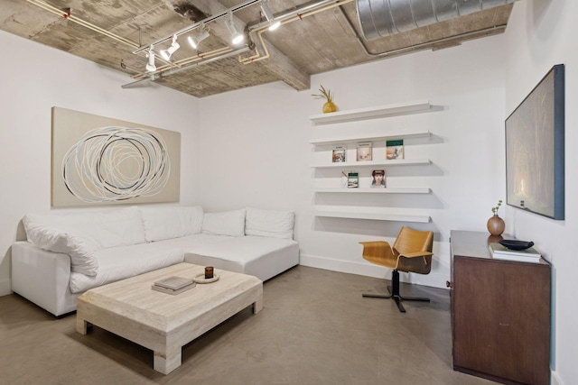 living room featuring finished concrete flooring and baseboards