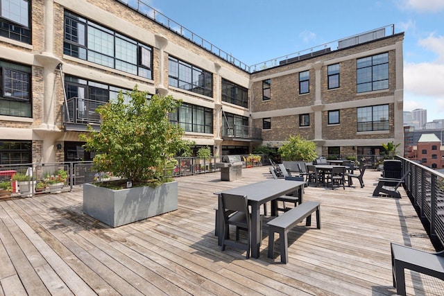 deck featuring outdoor dining area and area for grilling