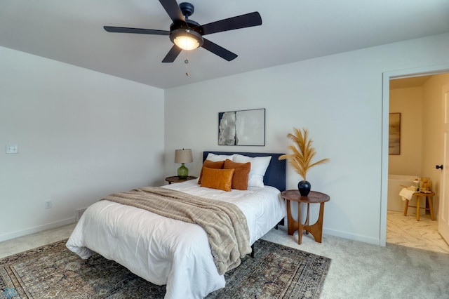 bedroom with carpet floors, baseboards, ceiling fan, and connected bathroom