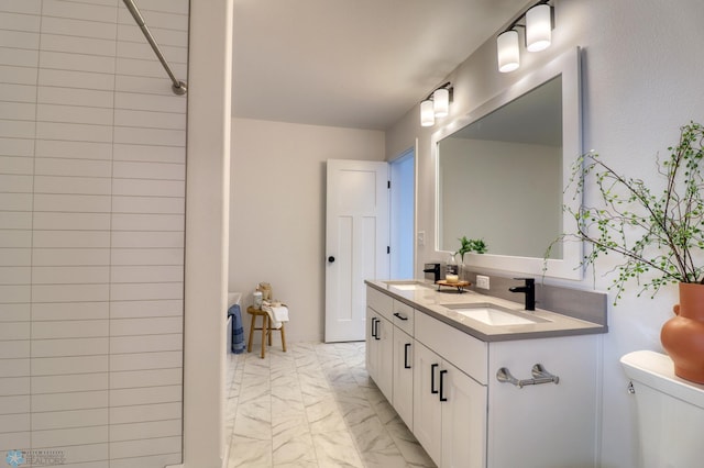full bath featuring marble finish floors, toilet, double vanity, and a shower