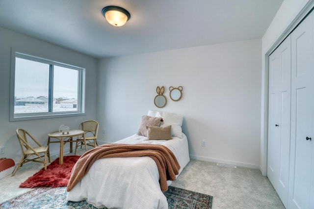 bedroom featuring a closet, carpet flooring, and baseboards