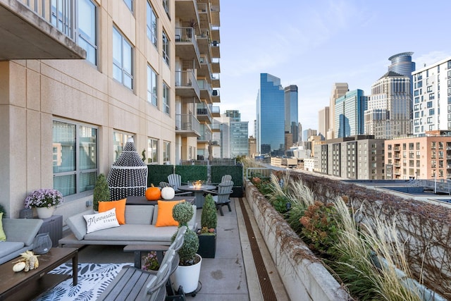 balcony with a fire pit and a view of skyline